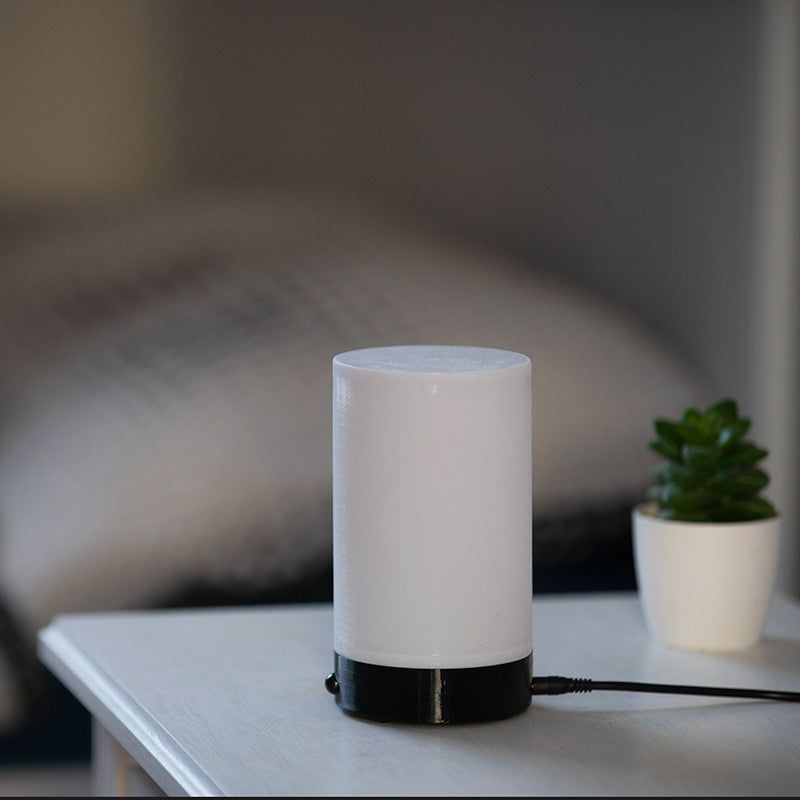 Sleep Phaser V3 switched off on a bedside table next to a plant