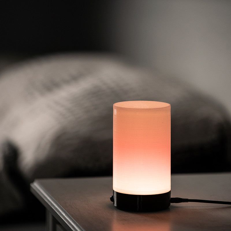 Sleep Phaser V3 on a bedside table glowing with warm evening light